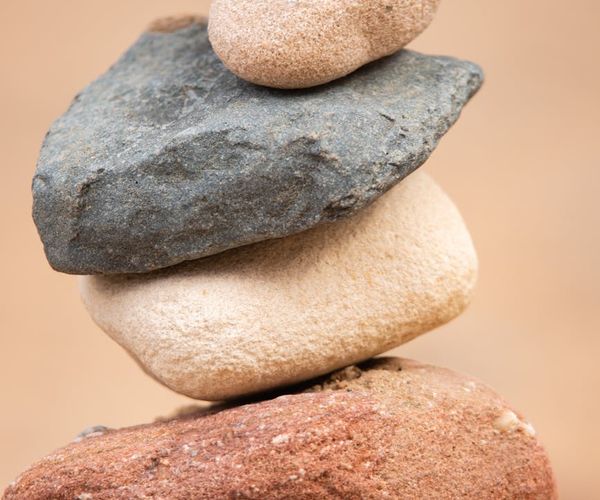 Abstract image of smooth stones stacked on top of each other.