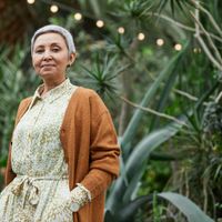 Portrait of a smiling woman with a natural background.